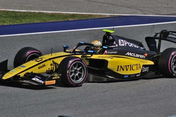 Gabriel Bortoleto in the yellow Invicta Racing Formula 2 car on track in Austria.