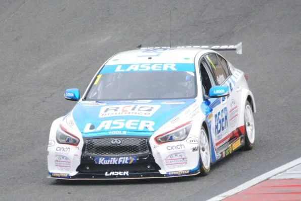The white and pale blue Laser Tools Racing Infiniti Q50 of Ash Sutton at Brands Hatch in 2021, carrying the reigning champion figure 1 on the windscreen.
