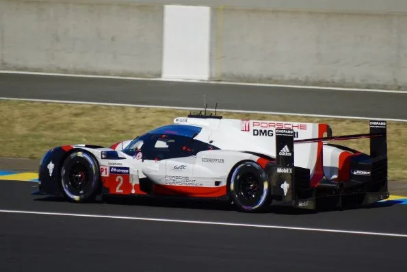The white, red and black Porsche 919 Hybrid, car 2, on track at the 2017 24 Hours of Le Mans, the race it won with Timo Bernhard, Brendon Hartley and Earl Bamber.