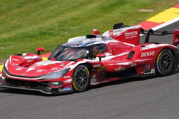 The red and white Toyota TR010 Hybrid, car 7, racing at Spa-Francorchamps in 2026, with Mike Conway, Kamui Kobayashi and Nyck de Vries named on the door.